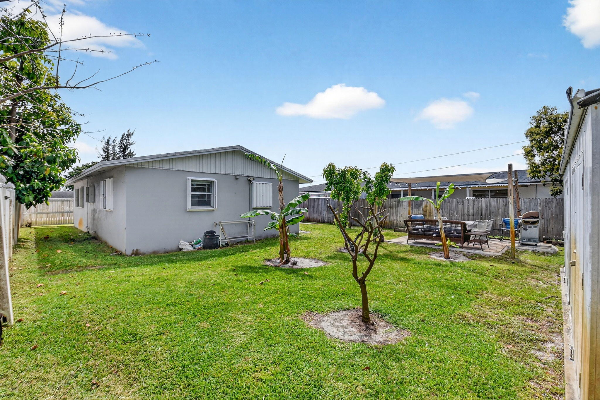 5721 Coconut Road West Palm Beach, FL 33413 - Photo 31 of 41 a view of a backyard with table and chairs