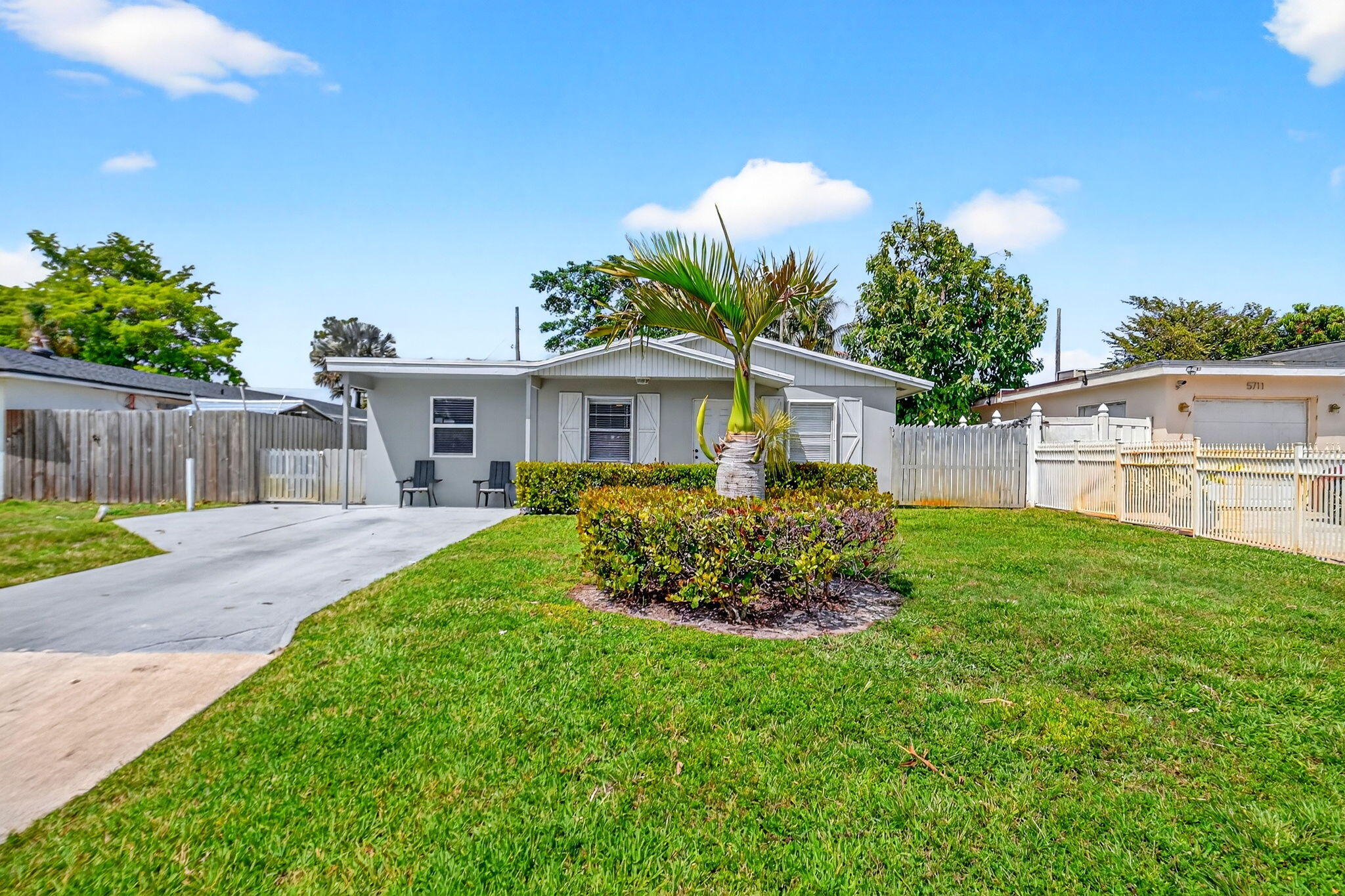 5721 Coconut Road West Palm Beach, FL 33413 - Photo 6 of 41 a front view of a house with a garden and plants