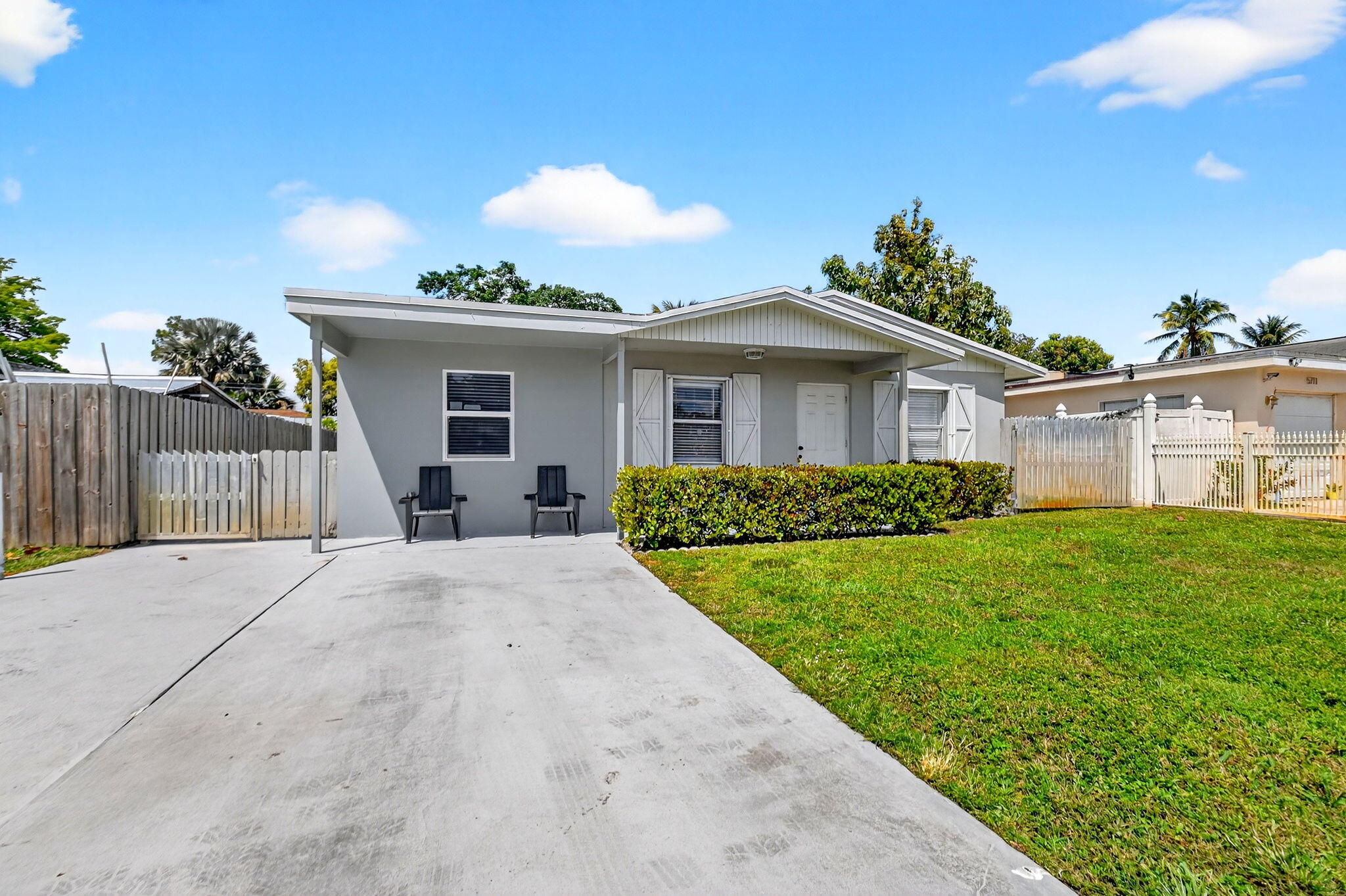 5721 Coconut Road West Palm Beach, FL 33413 - Photo 7 of 41 a front view of a house with a yard and potted plants