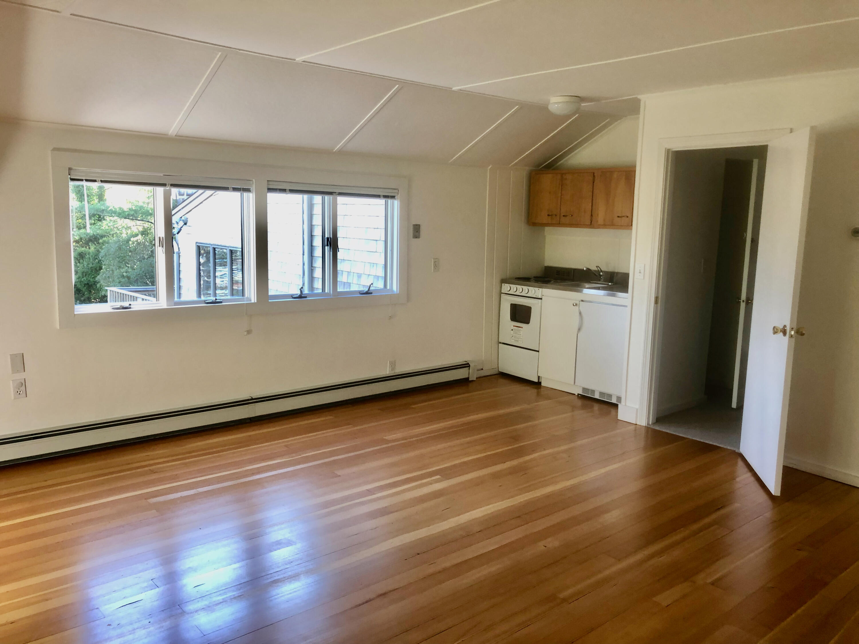 171 Monument Road Orleans, MA 02653 - Photo 30 of 47 a view of an empty room with window and wooden floor