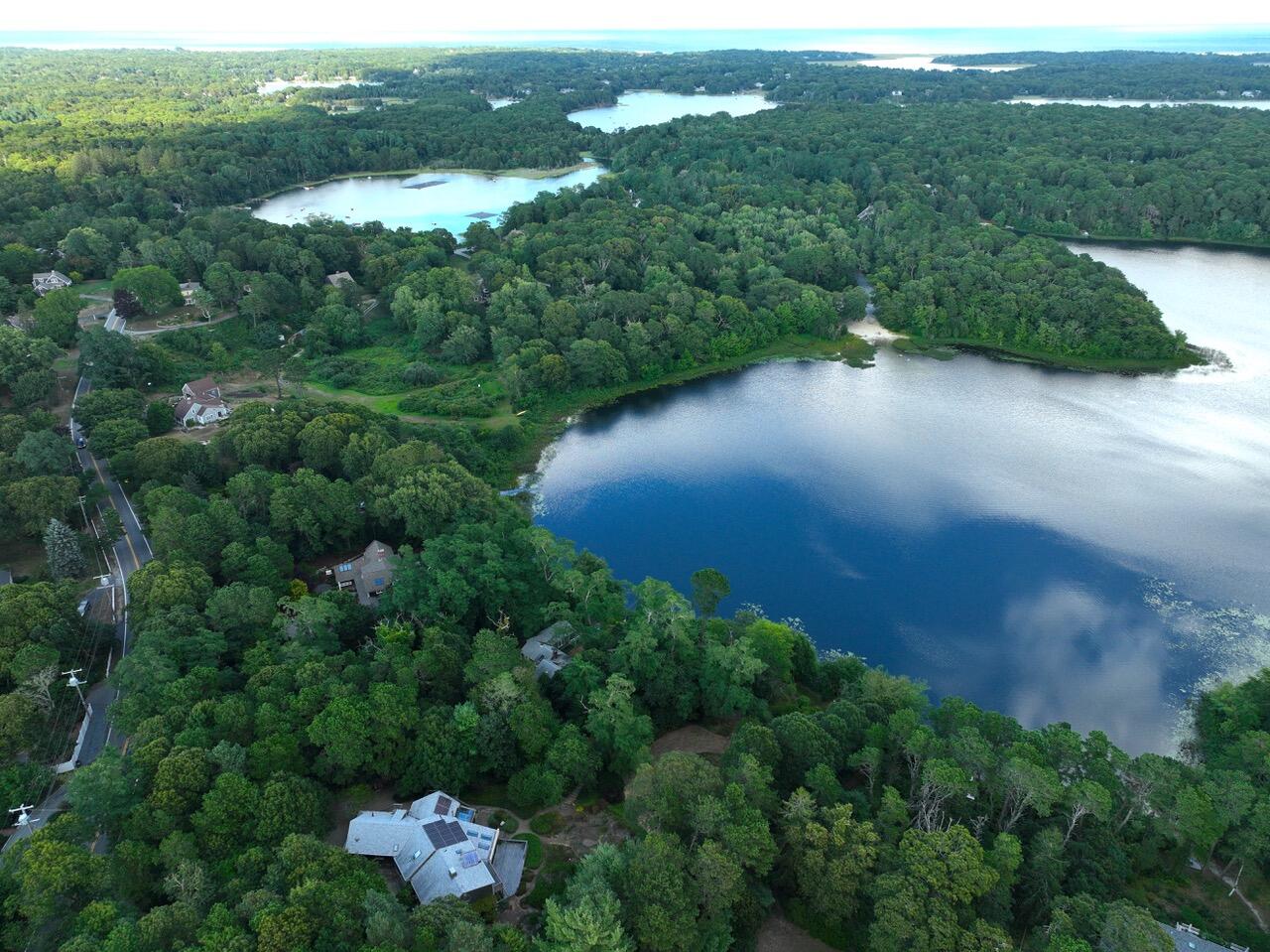 171 Monument Road Orleans, MA 02653 - Photo 3 of 47 an aerial view of a residential houses with outdoor space and trees all around