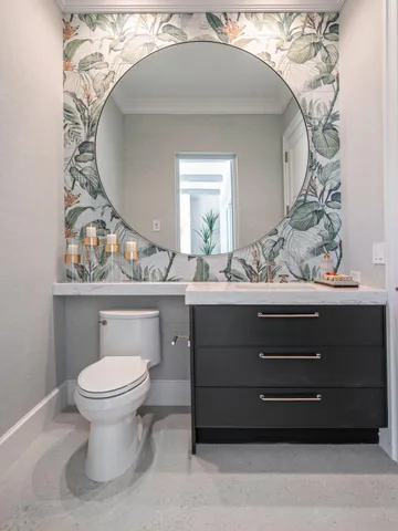 a bathroom with a toilet a sink and mirror