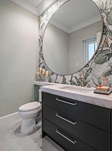 a bathroom with a toilet a sink and mirror