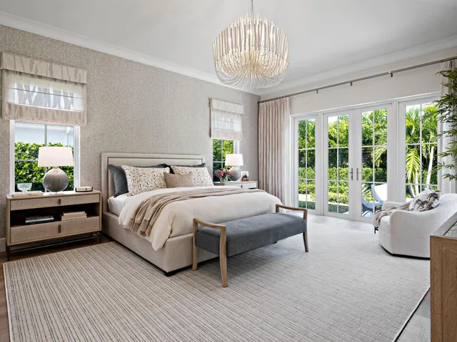 a bedroom with a large bed and a chandelier
