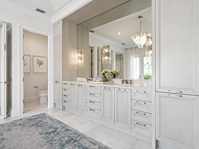 a spacious bathroom with a granite countertop sink a mirror and a shower