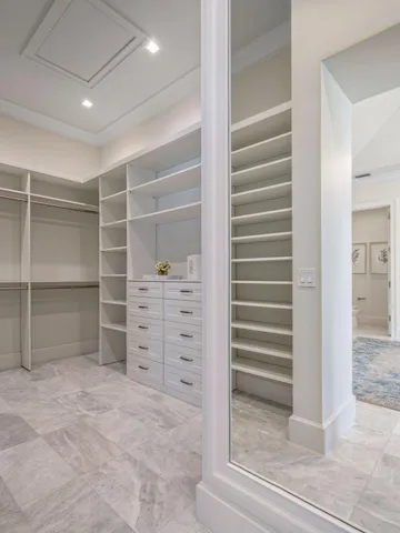a view of walk in closet with empty racks