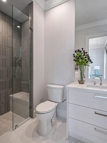 a bathroom with a sink a toilet and shower