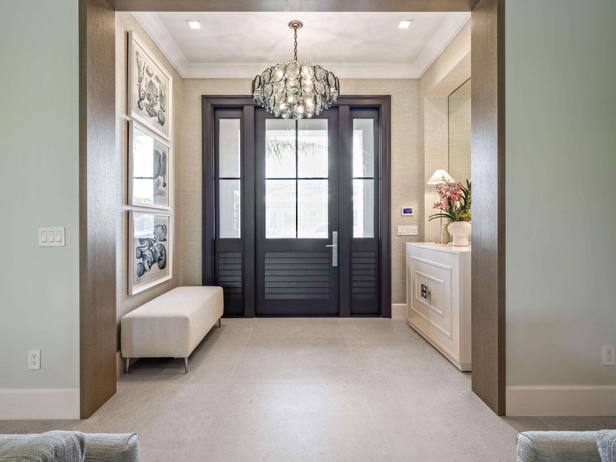 2913 Bluewater Cove Gulf Stream, FL 33483 - Photo 3 of 43 a bedroom with a bed and a chandelier