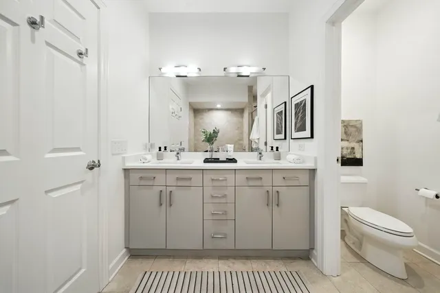 a spacious bathroom with a shower a sink and a toilet