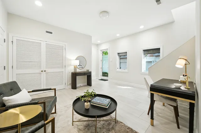 a living room with furniture and a wooden floor