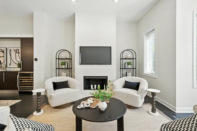 a living room with furniture a rug and a fireplace
