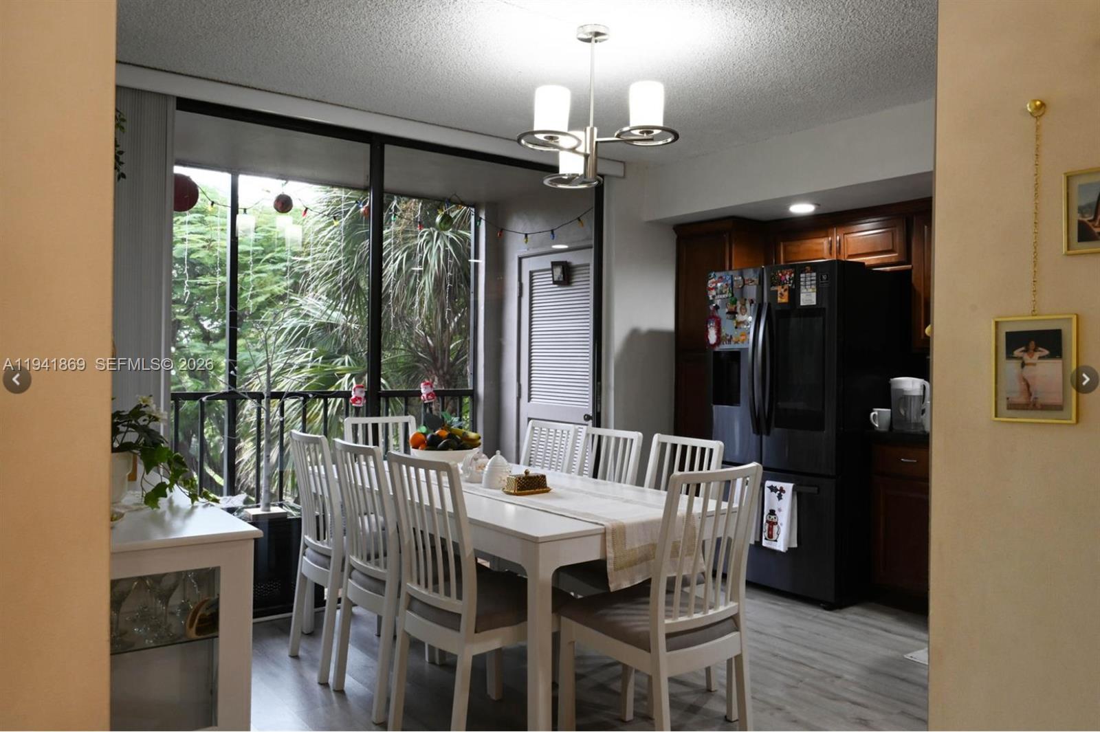 8400 Southwest 133rd Avenue Road, Unit 311 Miami, FL 33183 - Photo 5 of 11 a view of a dining room with furniture window and wooden floor