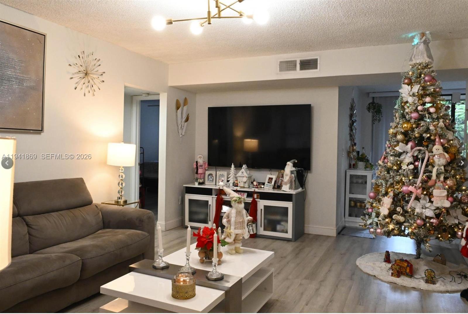 8400 Southwest 133rd Avenue Road, Unit 311 Miami, FL 33183 - Photo 7 of 11 a living room with furniture and a flat screen tv