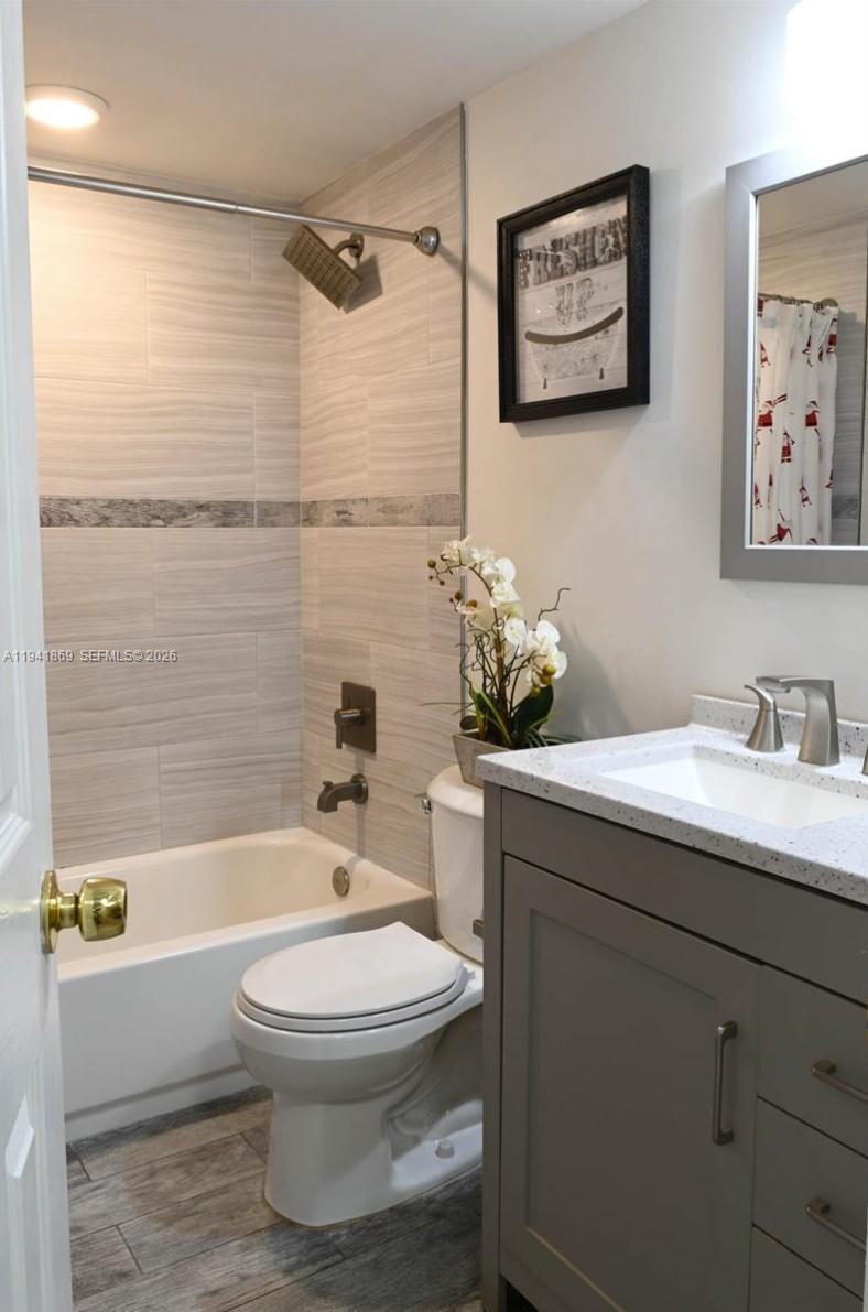 8400 Southwest 133rd Avenue Road, Unit 311 Miami, FL 33183 - Photo 9 of 11 a bathroom with a sink a toilet and shower