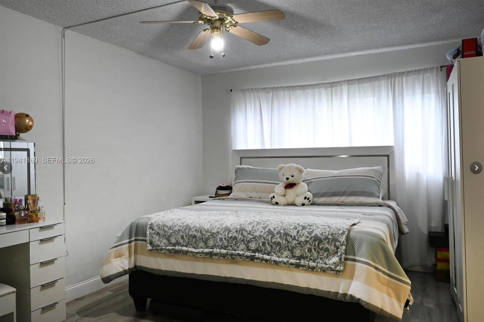 8400 Southwest 133rd Avenue Road, Unit 311 Miami, FL 33183 - Photo 10 of 11 a bedroom with a bed and window
