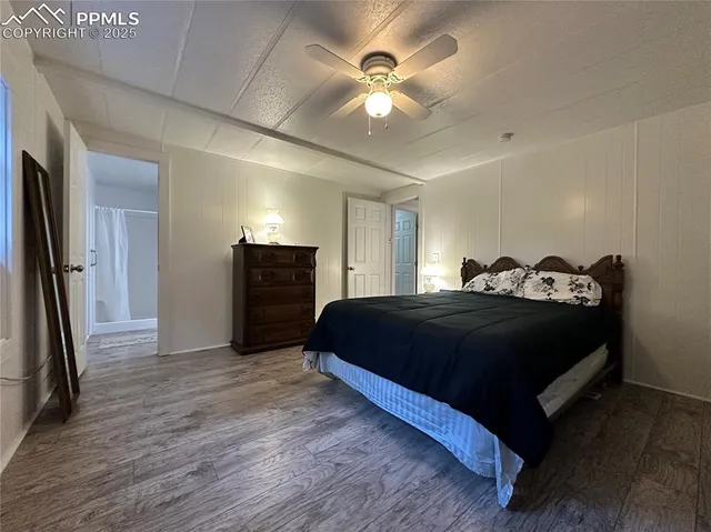 a bedroom with a bed and a ceiling fan
