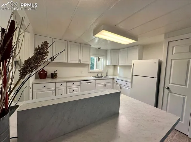 a kitchen with stainless steel appliances a refrigerator sink and cabinets