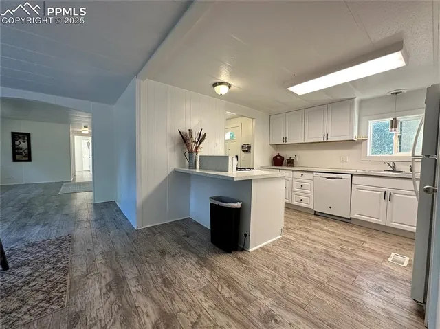 a kitchen with a sink cabinets and window