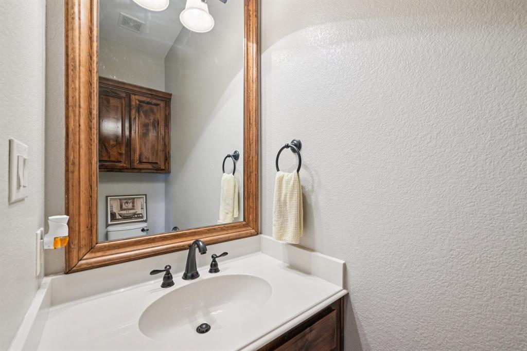 101 Maral Lane Azle, TX 76020 - Photo 12 of 36 a bathroom with a sink and a mirror
