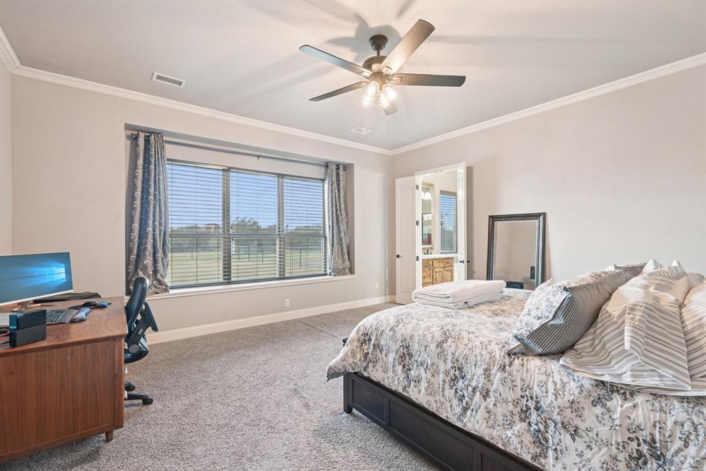 101 Maral Lane Azle, TX 76020 - Photo 13 of 36 a bedroom with a large bed and a window