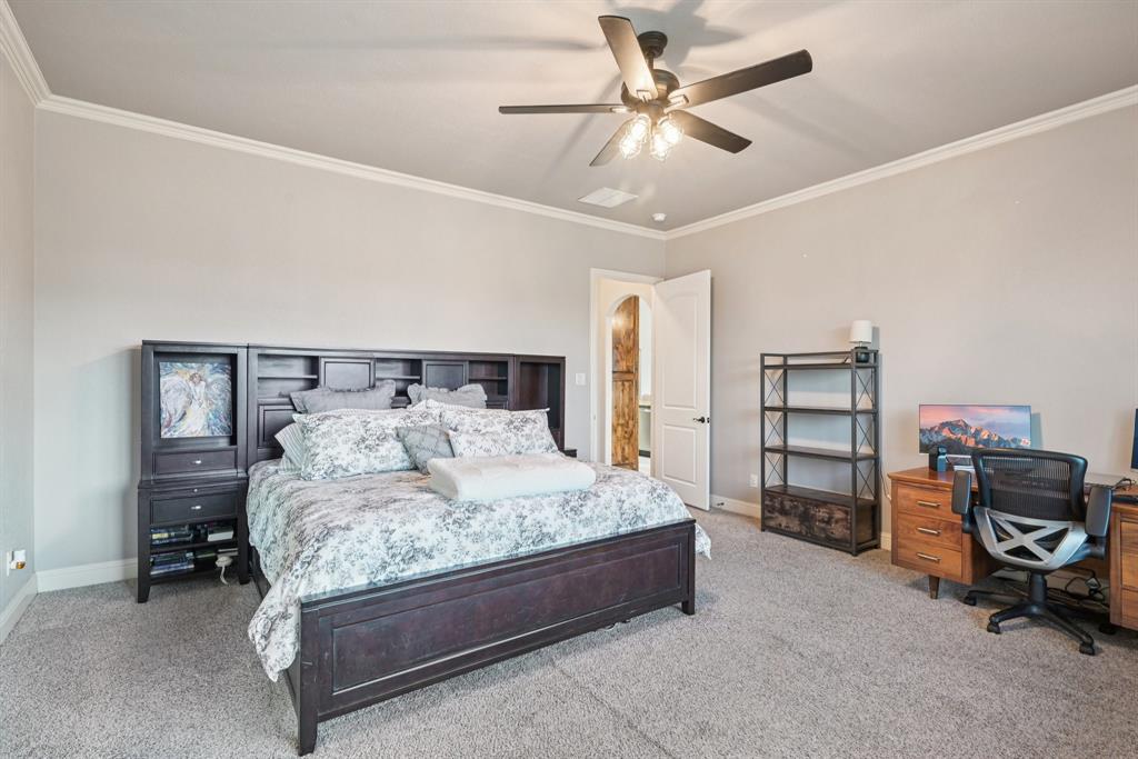 101 Maral Lane Azle, TX 76020 - Photo 14 of 36 a bedroom with a bed and a chandelier