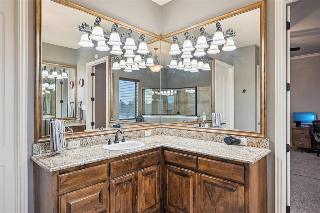 101 Maral Lane Azle, TX 76020 - Photo 16 of 36 a bathroom with a sink and a large mirror