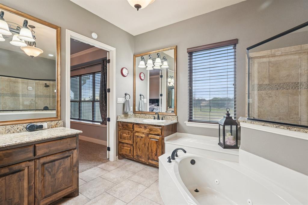 101 Maral Lane Azle, TX 76020 - Photo 17 of 36 a bathroom with a tub sink and mirror