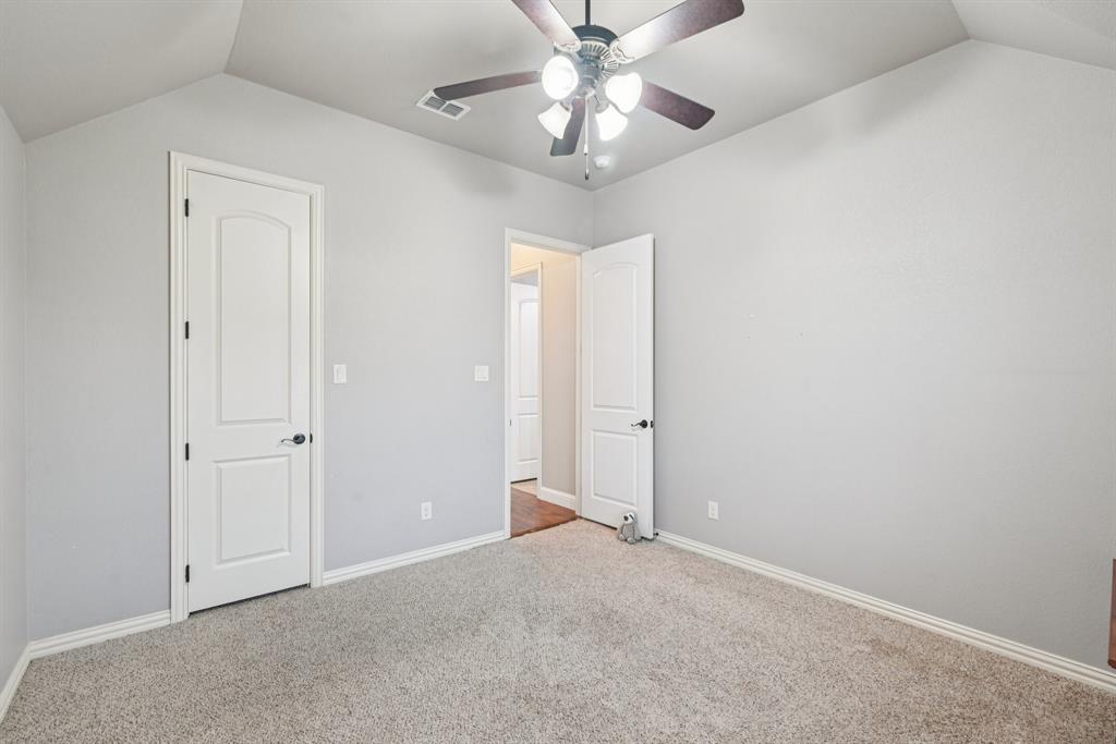 101 Maral Lane Azle, TX 76020 - Photo 20 of 36 an empty room with a chandelier fan and closet area