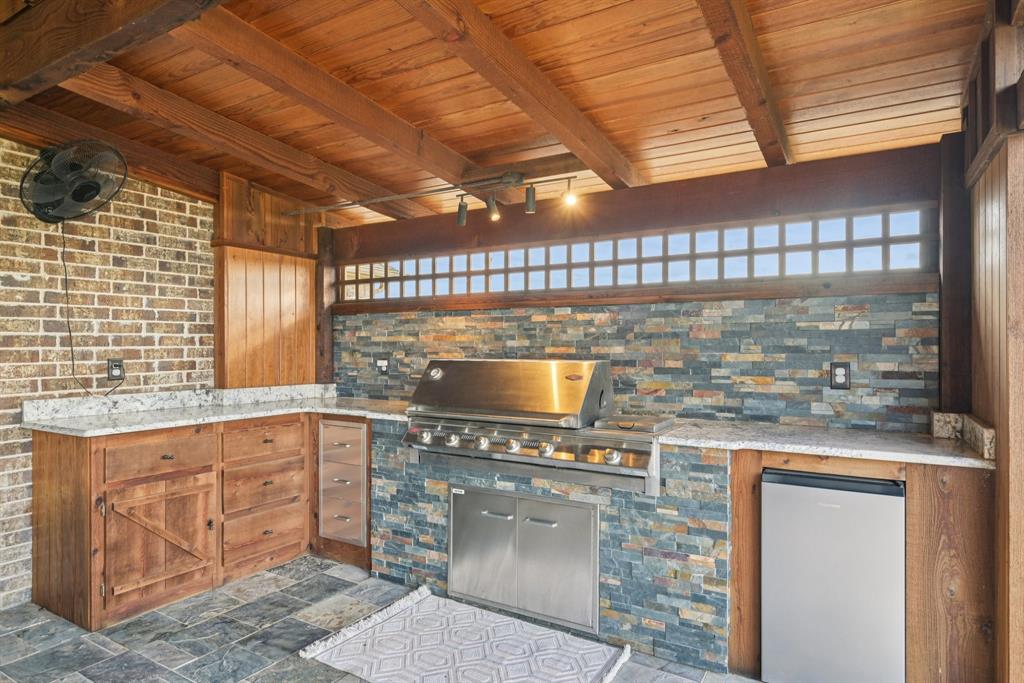 101 Maral Lane Azle, TX 76020 - Photo 24 of 36 a kitchen with granite countertop a stove a sink and a microwave