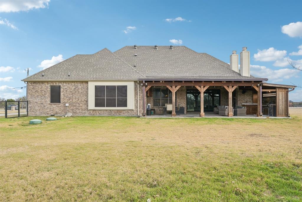 101 Maral Lane Azle, TX 76020 - Photo 31 of 36 a front view of a house with a garden