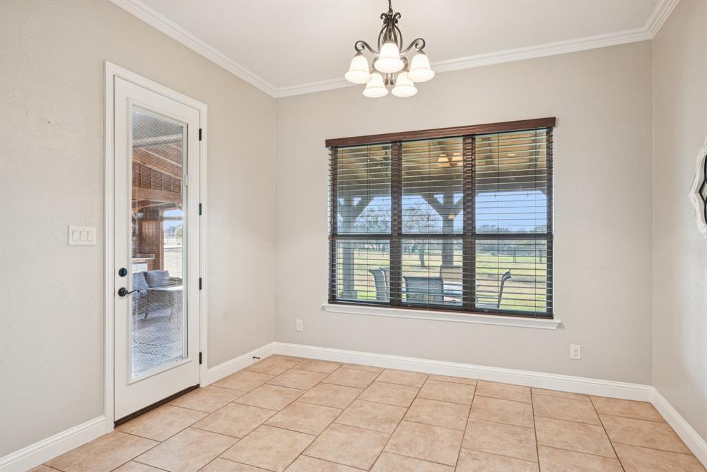 101 Maral Lane Azle, TX 76020 - Photo 7 of 36 an empty room with chandelier fan and windows