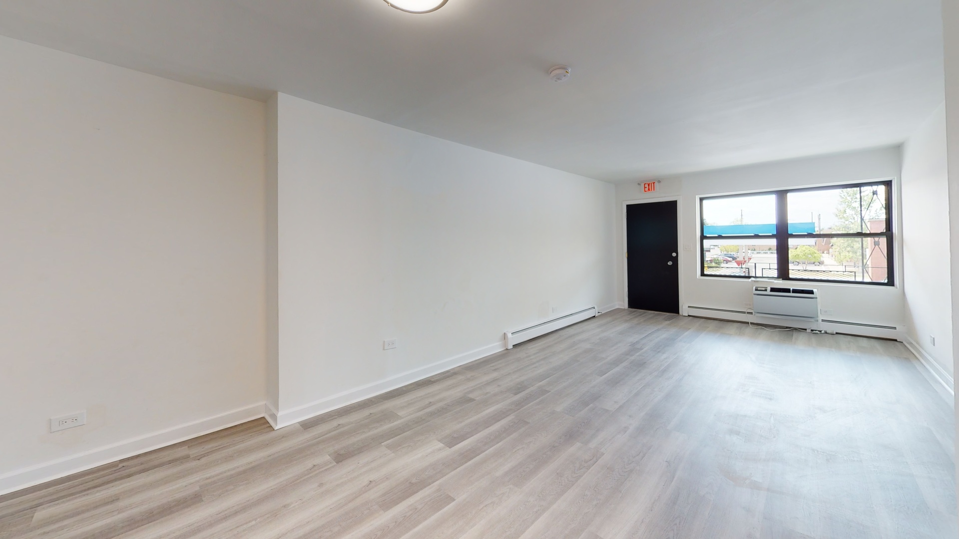 8100 Oakton Street, Unit 203 Niles, IL 60714 - Photo 12 of 15 wooden floor in an empty room with a window