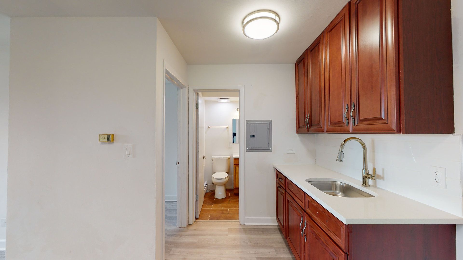 8100 Oakton Street, Unit 203 Niles, IL 60714 - Photo 3 of 15 a kitchen with stainless steel appliances granite countertop a sink and dishwasher a refrigerator with wooden floor