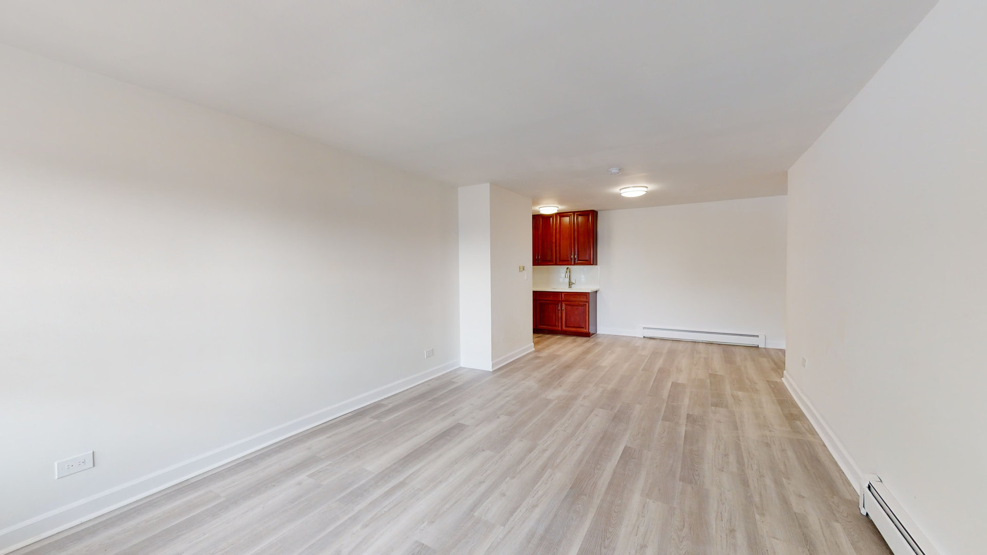 8100 Oakton Street, Unit 203 Niles, IL 60714 - Photo 6 of 15 a view of empty room with wooden floor