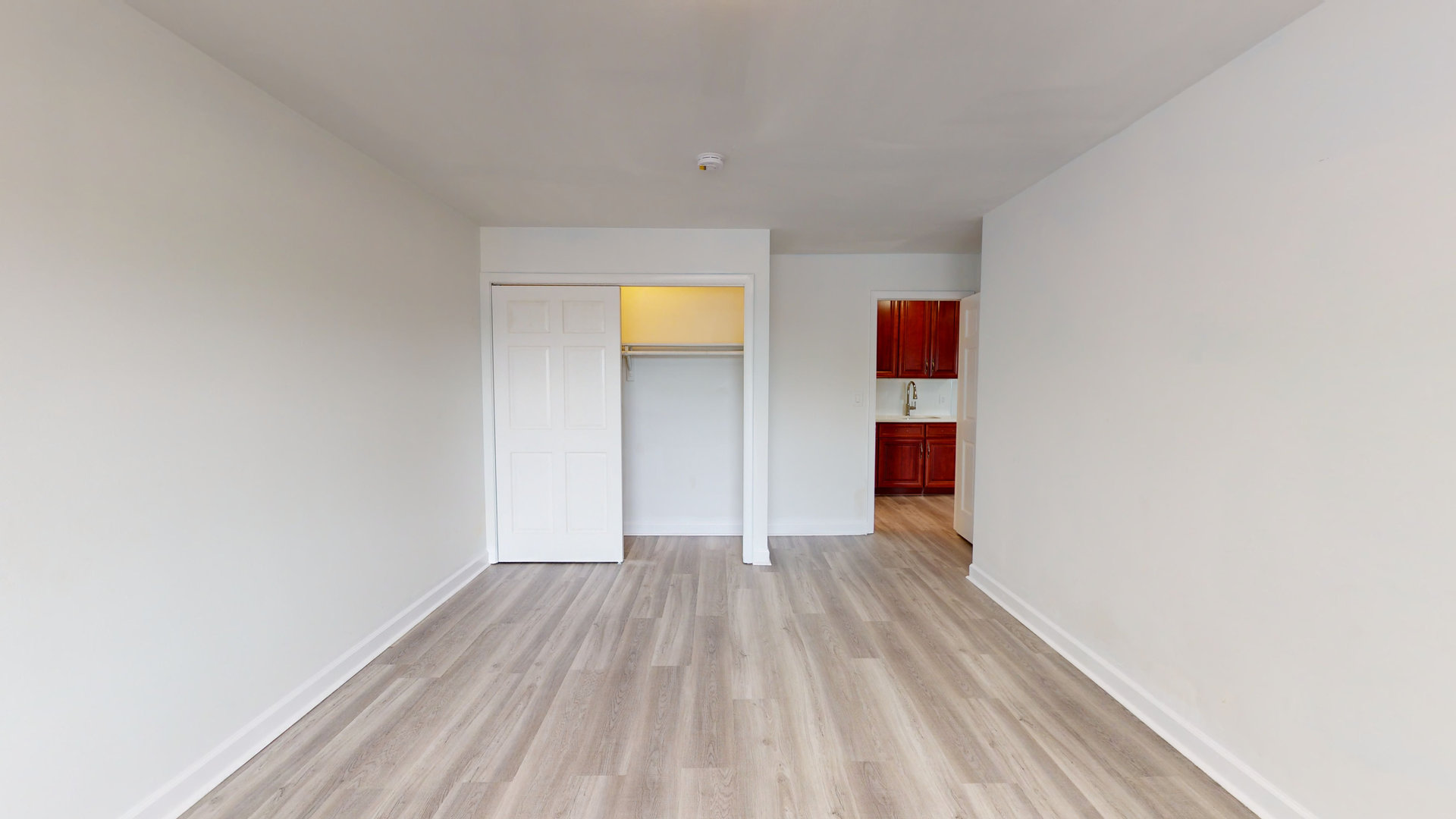 8100 Oakton Street, Unit 203 Niles, IL 60714 - Photo 9 of 15 a view of a room with wooden floor and a ceiling fan