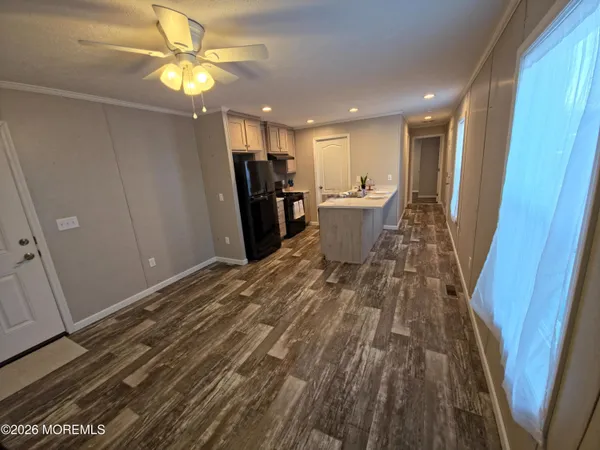 a view of a room with a window and a ceiling fan