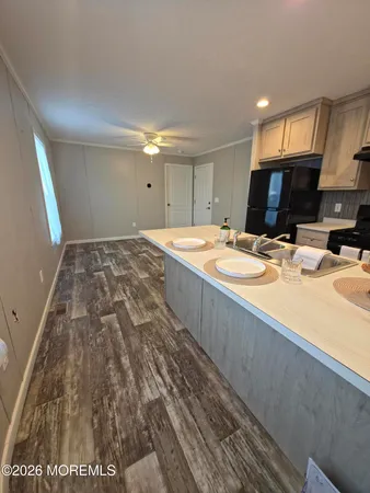 a room with a bed and a view of kitchen