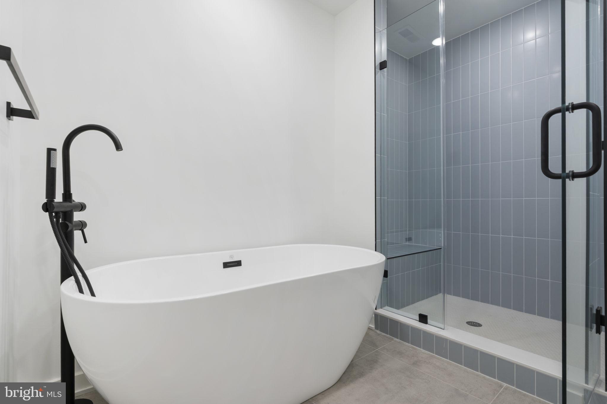 1602-4 Locust Street, Unit 202 Philadelphia, PA 19103 - Photo 17 of 25 a white bath tub sitting next to a bathroom