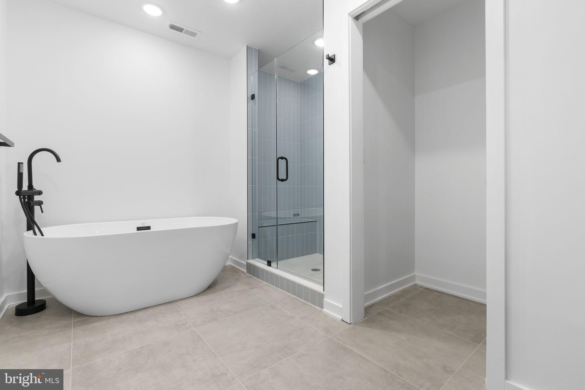 1602-4 Locust Street, Unit 202 Philadelphia, PA 19103 - Photo 18 of 25 a bathroom with a tub and shower