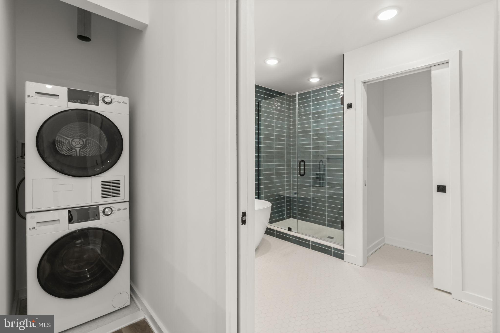 1602-4 Locust Street, Unit 202 Philadelphia, PA 19103 - Photo 21 of 25 a view of a hallway with washer and dryer