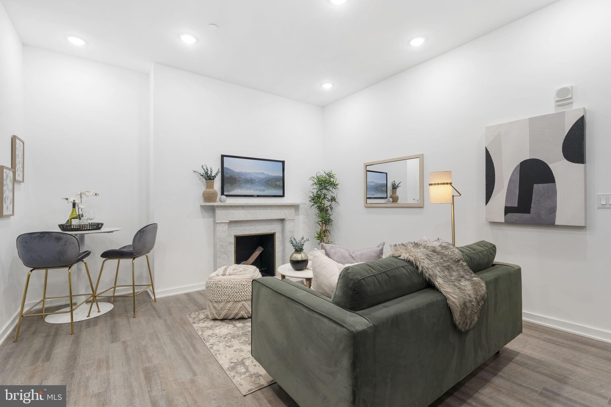 1602-4 Locust Street, Unit 202 Philadelphia, PA 19103 - Photo 7 of 25 a living room with furniture and a fireplace
