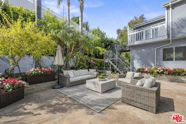 a view of a patio with couches and potted plants