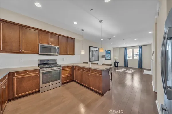 a large kitchen with stainless steel appliances granite countertop a stove and a sink