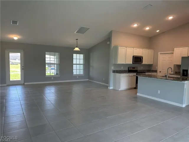 a view of a kitchen with microwave and cabinets