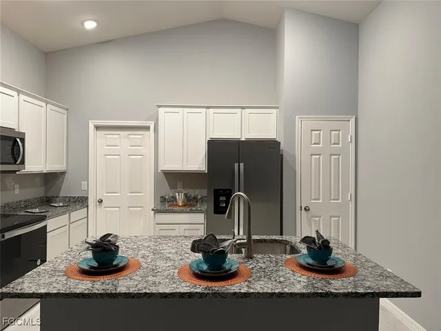 a kitchen with a sink and a stove top oven