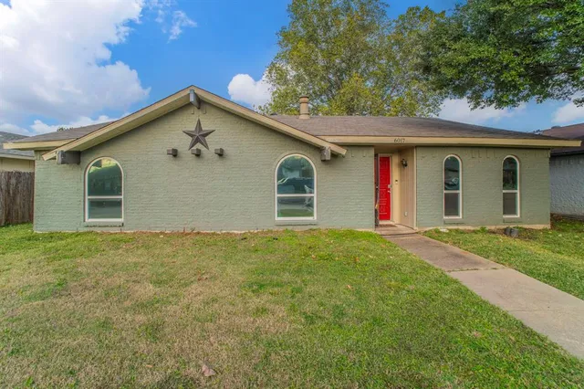 a view of a house with a yard and garage