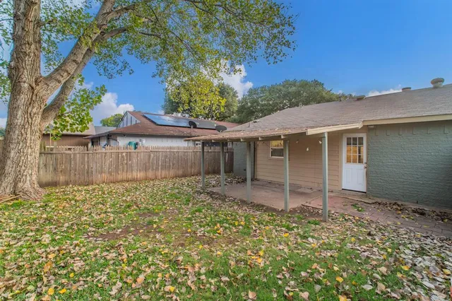 a view of a house with wooden fence
