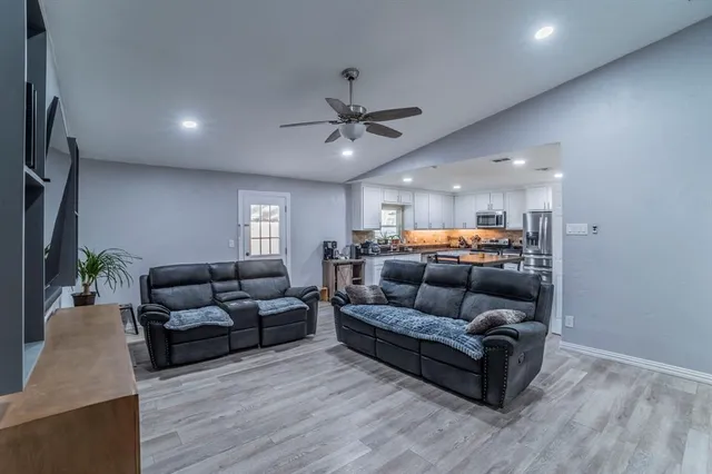 a living room with furniture and a chandelier