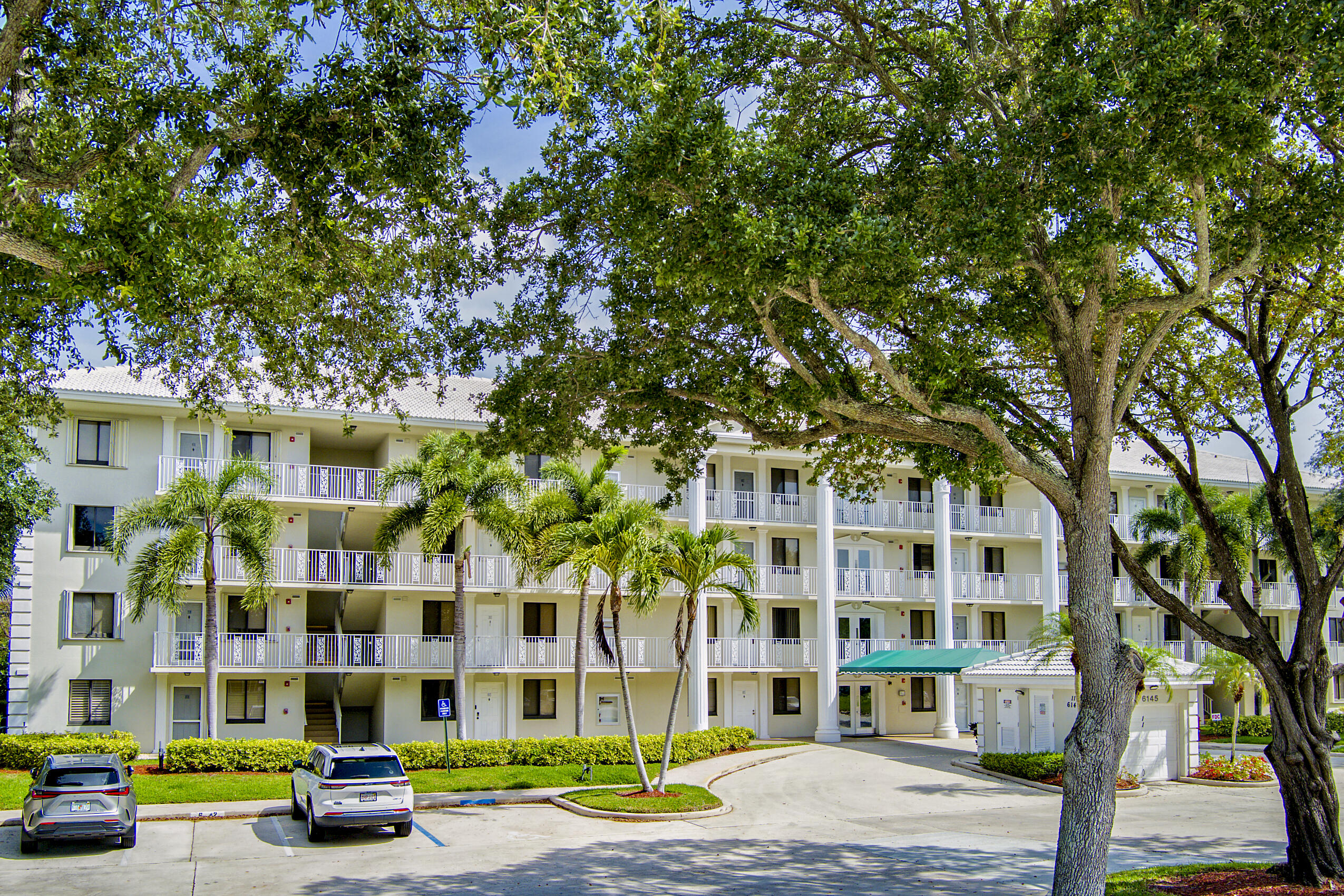 6145 Balboa Circle, Unit 103 Boca Raton, FL 33433 - Photo 30 of 31 a car parked in front of a building