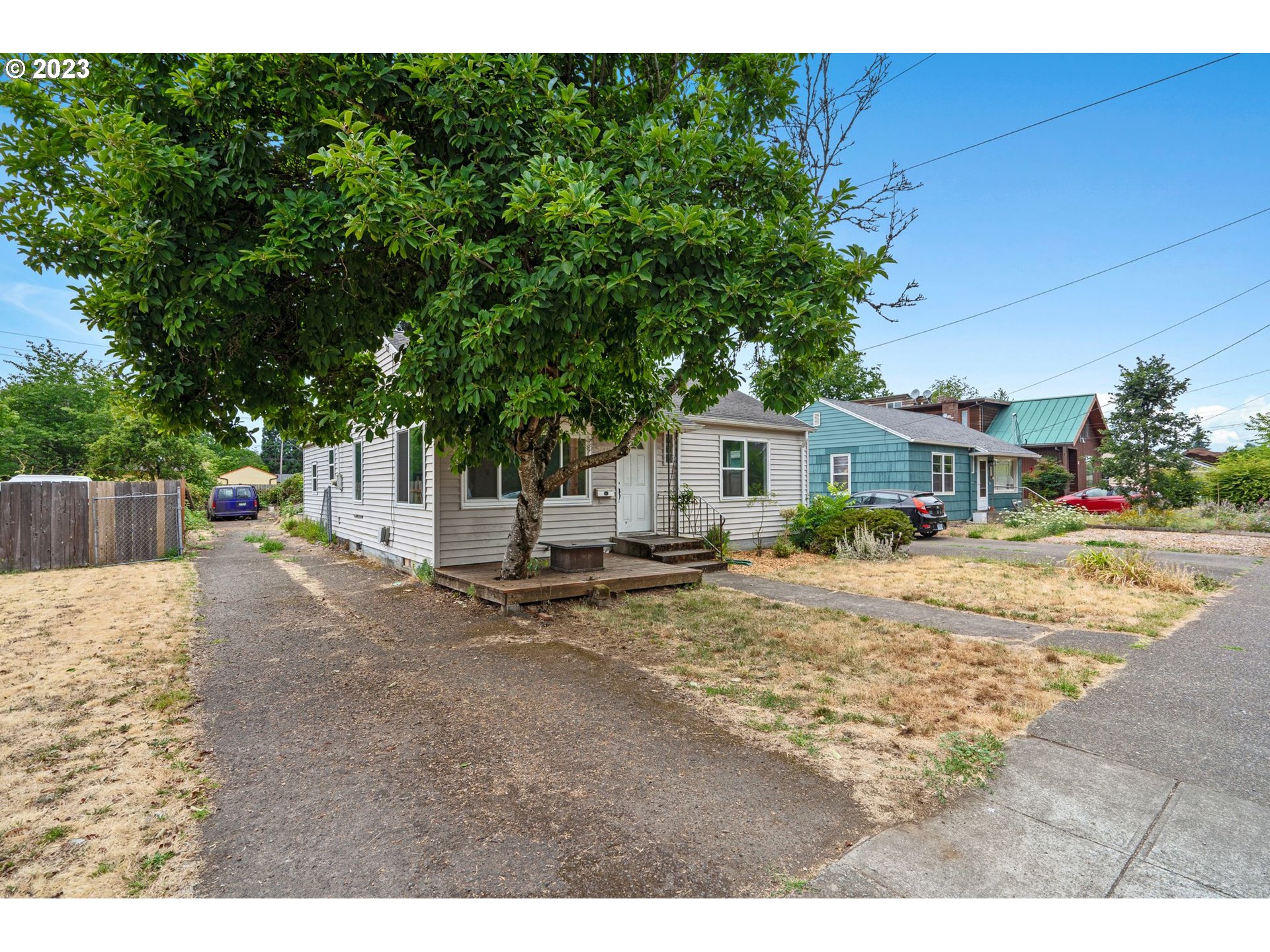 5119 Southeast 68th Avenue Portland, OR 97206 - Photo 1 of 43 a view of a house with a patio and a yard